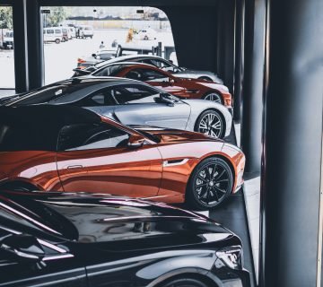 Five assorted color cars parked inside room 1231643 360x320